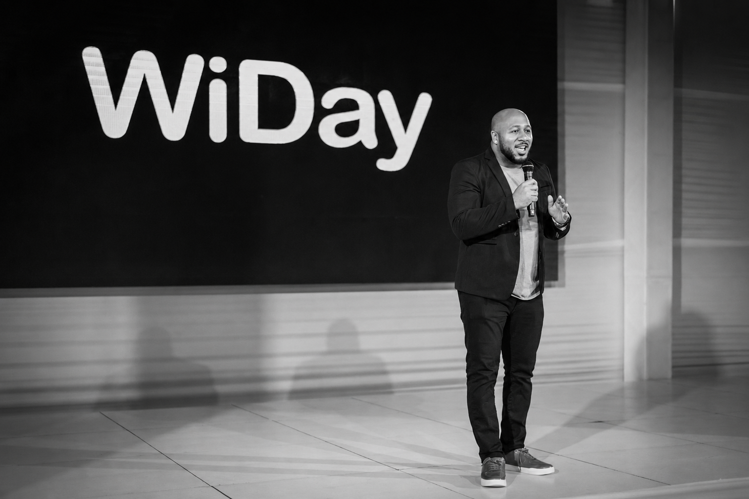 Keron Rose speaking on stage at WiDay